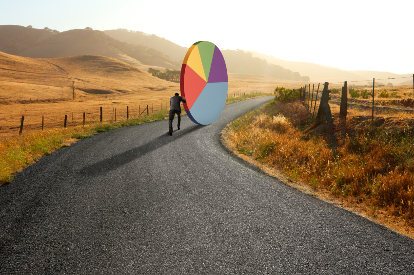 stock-photo-48712416-businessman-pushing-pie-chart-down-rural-road